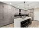 Stylish kitchen featuring gray cabinets, stainless steel appliances, a large island with barstool seating, and modern pendant lighting at 4170 N 154Th Dr, Goodyear, AZ 85395