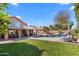 Lush backyard with mature landscaping, pool, covered patio offering an ideal space for outdoor living at 4440 W Fallen Leaf Ln, Glendale, AZ 85310