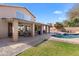 Expansive backyard with covered patio, sparkling pool, and lush green grass, perfect for outdoor gatherings at 4440 W Fallen Leaf Ln, Glendale, AZ 85310