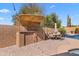 Outdoor barbecue area with a built-in grill, bar seating, and a charming pergola, perfect for entertaining at 4440 W Fallen Leaf Ln, Glendale, AZ 85310