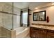 Bright bathroom showcasing a tiled shower, soaking tub, and elegant vanity at 4440 W Fallen Leaf Ln, Glendale, AZ 85310