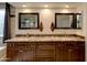 Bathroom highlighting dual sinks with ornate wood cabinets and granite countertops at 4440 W Fallen Leaf Ln, Glendale, AZ 85310