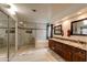 Luxury bathroom with dual sinks, walk-in shower, and soaking tub at 4440 W Fallen Leaf Ln, Glendale, AZ 85310