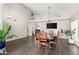 Open dining area with a vaulted ceiling, hardwood floors, and space for a large dining table at 4440 W Fallen Leaf Ln, Glendale, AZ 85310