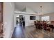 Open concept dining room with wood floors and decorative lighting fixture at 4440 W Fallen Leaf Ln, Glendale, AZ 85310