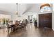 Bright dining room with hardwood floors, a vaulted ceiling, and a large dining table at 4440 W Fallen Leaf Ln, Glendale, AZ 85310