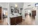 Elegant entryway with dark wood floors, marble-topped console, and arched doorway at 4440 W Fallen Leaf Ln, Glendale, AZ 85310