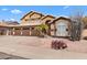 Front exterior view of a home with a well-kept lawn, a three-car garage, and desert landscaping at 4440 W Fallen Leaf Ln, Glendale, AZ 85310