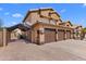 Side view of home with a three-car garage and a driveway with covered parking at 4440 W Fallen Leaf Ln, Glendale, AZ 85310