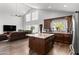 Open concept kitchen with granite counters, dark cabinets, and stainless steel appliances at 4440 W Fallen Leaf Ln, Glendale, AZ 85310