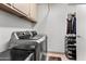 Functional laundry room with storage cabinets, washer, and dryer at 4440 W Fallen Leaf Ln, Glendale, AZ 85310