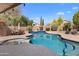 Beautiful backyard with a sparkling pool, lush landscaping, and ample space for outdoor entertaining at 4440 W Fallen Leaf Ln, Glendale, AZ 85310