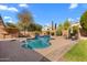 Inviting backyard showcasing a sparkling pool, lush landscaping, and spacious patio areas, ideal for relaxation at 4440 W Fallen Leaf Ln, Glendale, AZ 85310