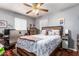 This bedroom offers a cozy space with a bed, a ceiling fan and lots of natural light from the windows at 4512 E Turney Ave, Phoenix, AZ 85018