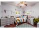 This bedroom features a bright, airy interior with a ceiling fan, a bed and natural light at 4512 E Turney Ave, Phoenix, AZ 85018