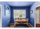 Cozy dining area with bright blue walls, a charming table set for four, and plenty of natural light at 4512 E Turney Ave, Phoenix, AZ 85018