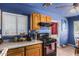 Functional kitchen featuring warm wood cabinets, modern appliances, and a window for natural light at 4512 E Turney Ave, Phoenix, AZ 85018