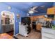 Bright, blue kitchen with classic wood cabinets, black appliances, and an open layout for easy entertaining at 4512 E Turney Ave, Phoenix, AZ 85018