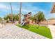 Paver backyard featuring a wooden play structure and green artificial grass at 4705 W Annette Cir, Glendale, AZ 85308