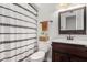 Bathroom featuring a patterned shower curtain, a wooden vanity, and a toilet at 4705 W Annette Cir, Glendale, AZ 85308