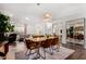 Bright dining room with decorative lighting fixture, wood floors, and open-concept floor plan at 4705 W Annette Cir, Glendale, AZ 85308