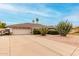 Single-story home with desert landscaping, a two-car garage and a well maintained exterior and lawn at 4705 W Annette Cir, Glendale, AZ 85308