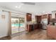 Contemporary kitchen with dark wood cabinets, granite countertops, and stainless steel appliances, with seamless indoor-outdoor access at 4705 W Annette Cir, Glendale, AZ 85308