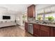 This cozy kitchen includes stainless steel appliances, granite countertops, and dark wood cabinets for a warm, modern space at 4705 W Annette Cir, Glendale, AZ 85308