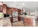 Well-equipped kitchen with granite countertops, stainless steel appliances, and a decorative backsplash for a gourmet experience at 4705 W Annette Cir, Glendale, AZ 85308