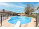 Sparkling pool with diving board is fenced and surrounded by grass at 4705 W Annette Cir, Glendale, AZ 85308