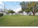 A view of the spacious backyard, showcasing lush green grass and trees at 5307 E Cambridge Ave, Phoenix, AZ 85008