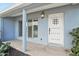 Close up of the front porch with a white door and pillar, along with a window with shutters at 5307 E Cambridge Ave, Phoenix, AZ 85008