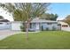 Charming one-story home with a well-manicured lawn and mature shade tree at 5307 E Cambridge Ave, Phoenix, AZ 85008