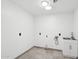 A bright laundry room featuring a utility sink and modern fixtures at 5307 E Cambridge Ave, Phoenix, AZ 85008