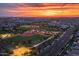 Aerial view showcases community baseball fields and green spaces under a vivid sunset at 5340 S Sabrina --, Mesa, AZ 85212