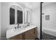 Dual sink bathroom vanity with tile flooring, contemporary mirrors, and modern lighting at 5340 S Sabrina --, Mesa, AZ 85212