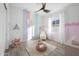 Charming Bedroom with pastel colors, playful wall designs, and ceiling fan at 5340 S Sabrina --, Mesa, AZ 85212