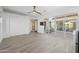 Bright living room with wood-look tile flooring, sliding glass doors to patio, and white walls at 5340 S Sabrina --, Mesa, AZ 85212