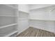 Spacious walk-in closet featuring custom shelving and wood-look flooring for ample storage at 5340 S Sabrina --, Mesa, AZ 85212