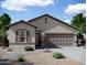 Charming single-story home featuring a desert landscape, neutral stucco exterior and an attached two-car garage at 6078 E Artemis Dr, Florence, AZ 85132