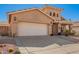 Tan home with a white garage door and desert landscaping is displayed at 6531 E Star Valley St, Mesa, AZ 85215