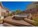 Relaxing backyard hot tub nestled in desert landscape and privacy wall at 6531 E Star Valley St, Mesa, AZ 85215