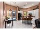 Bright eat-in kitchen featuring white cabinets, black appliances, central island, and a blue exterior door at 6531 E Star Valley St, Mesa, AZ 85215