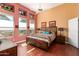 Comfortable main bedroom features a ceiling fan, warm tones, wood floors, and plentiful natural light at 6531 E Star Valley St, Mesa, AZ 85215