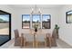 Bright dining room with modern chandelier and views of the outdoor space at 6735 N 9Th Dr, Phoenix, AZ 85013