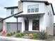 Contemporary home with a white exterior, a gray garage door, and a well-maintained front yard at 6735 N 9Th Dr, Phoenix, AZ 85013