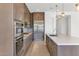 Stylish kitchen with stainless appliances, ample counter space, and modern lighting fixtures at 6735 N 9Th Dr, Phoenix, AZ 85013