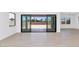Bright living space with tile flooring and large sliding glass doors that brings natural light inside at 6735 N 9Th Dr, Phoenix, AZ 85013