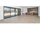 Open-concept living space with sliding glass doors, tile flooring and connecting access to the kitchen at 6735 N 9Th Dr, Phoenix, AZ 85013