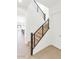 Modern staircase with wooden steps, black railings, and white walls offering a sleek design at 6735 N 9Th Dr, Phoenix, AZ 85013